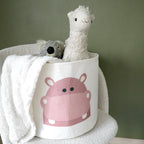 En stol med en kurv for oppbevaring av leker og kosedyr til barn, med flodhestmotiv